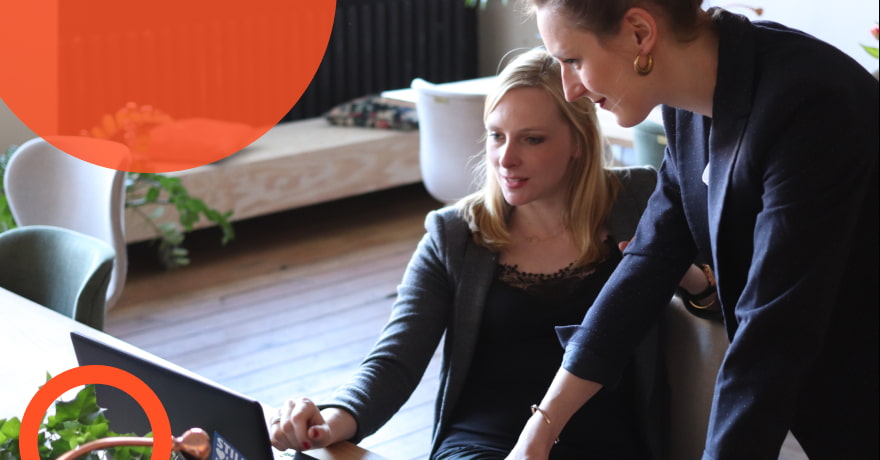 two women looking at a laptop