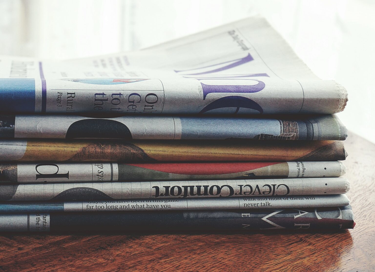 A stack of newspapers sitting on a table.