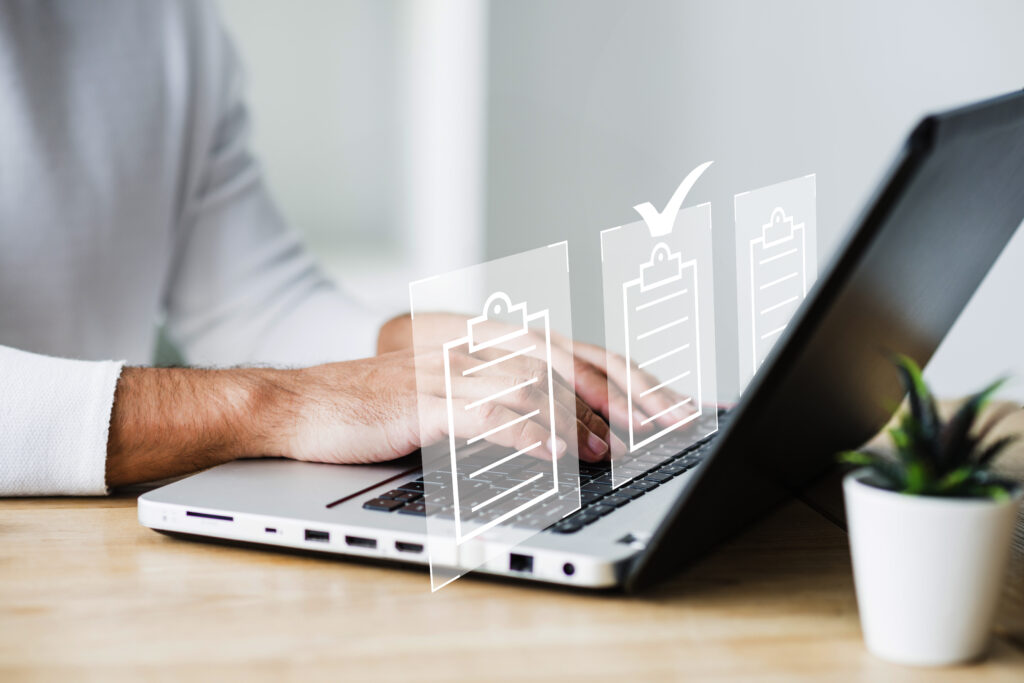 Person typing on a laptop with overlayed checklist icons.